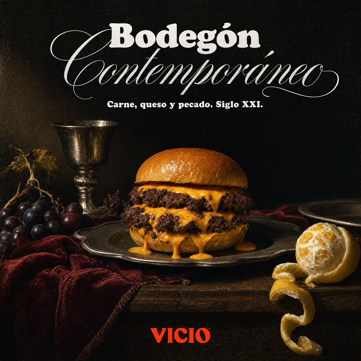 Anuncio de Vicio: una hamburguesa como un bodegón clásico, con uvas, una copa y un limón. «Bodegón contemporáneo».